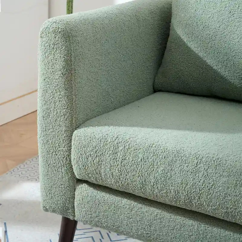 Sillón tapizado verde 26.77 con patas de madera maciza