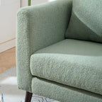 Sillón tapizado verde 26.77 con patas de madera maciza